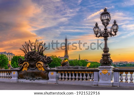 Street lantern on the Alexandre III Bridge with the Eiffel Tower in the background in Paris, France. Architecture and landmarks of Paris. Postcard of Paris