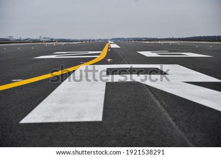 Tarmac detail on a newly constructed airplane runway Royalty-Free Stock Photo #1921538291