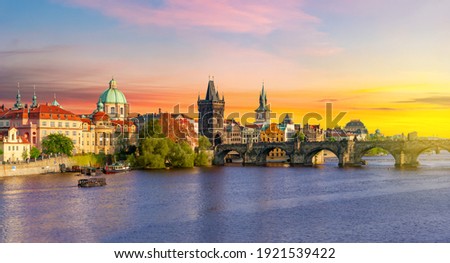 Classic Prague panorama with Old Town Bridge Tower and Charles bridge over Vltava river at sunset, Czech Republic Royalty-Free Stock Photo #1921539422
