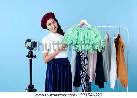 Asian young woman live streaming for sale fashion clothing is blogger presenting for social people.Her is influencer in social online.