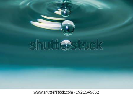 waterdrops falling down  in blue Royalty-Free Stock Photo #1921546652