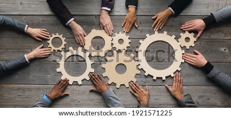 Business people connect golden gear together at meeting table, success cooperation teamwork concept Royalty-Free Stock Photo #1921571225