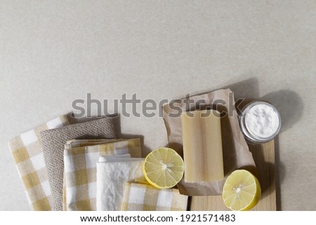 Natural cleaning products group of objects lemon, soda, natural soap, linen towel, sponge on a light background, horizontal photo, place for an inscription, minimalism, lifestyle