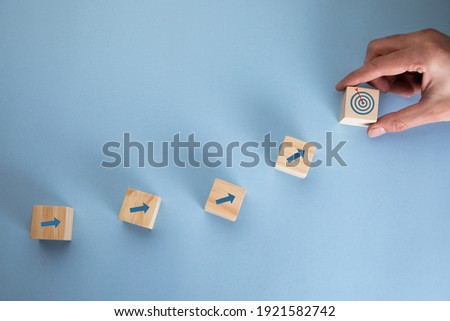 young business man holding cubes and target Royalty-Free Stock Photo #1921582742