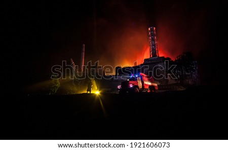 Creative artwork decoration. Chernobyl nuclear power plant at night. Layout of Chernobyl station during nuclear reactor explosion. Fire fighters at work. Selective focus Royalty-Free Stock Photo #1921606073