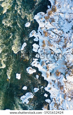 Top aerial view to the wild Ukrainian nature. Mountain river from above. Winter holiday. Active lifestyle. Drone photography.