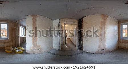 360 Degree panoramic sphere photo of construction working being done on an old British terrace house showing a small bedroom with wooden door frames and new walls being put up in the room