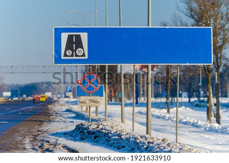 Road signs for drivers on the road, on a winter sunny day