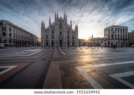 Beautiful scenic picture of Piazza Duomo of Milan Italy at sunrise with sun star