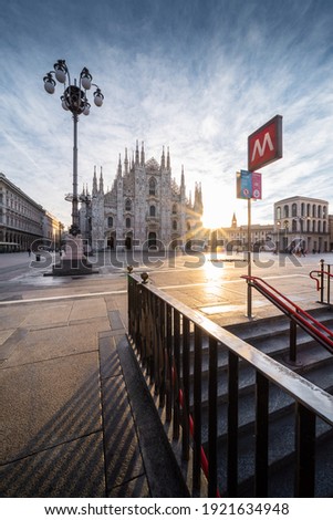 Beautiful scenic picture of Piazza Duomo of Milan at sunrise with railing in the foreground
