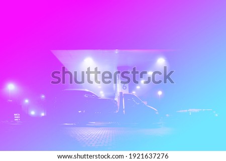 Colorful impression of a petrol station in foggy night scenery