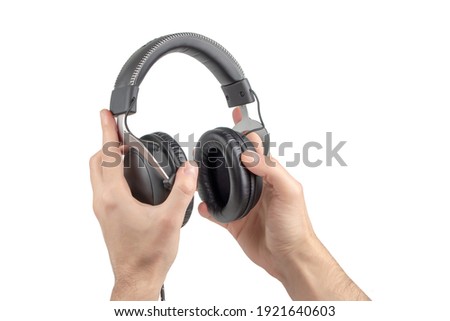 Hands Holding Headphones on White Background.