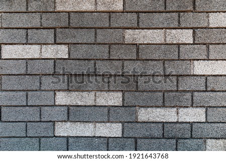 brick wall texture in gray tones with some white bricks
