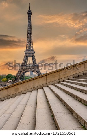 Eiffel Tower in Paris Europe at sunrise photographed from the Trocadero steps with lead in lines and orange background