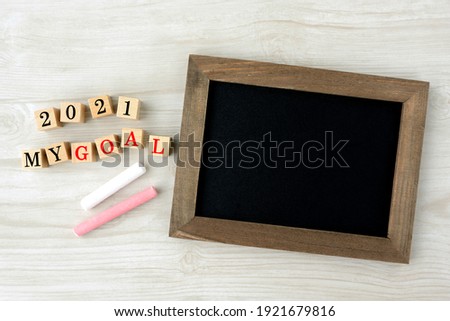Wooden blocks with 2021 GOAL word and black board with chalks