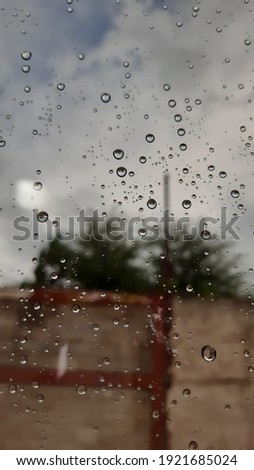 photograph taken from behind a window with the rain posing static on it as a texture and background