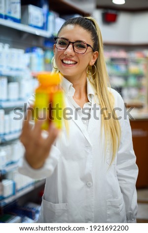 Pharmacist holding a jar of pills