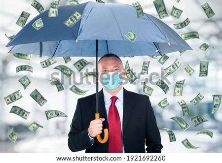 Happy man holding an umbrella in a money rain, covid coronavirus business concept