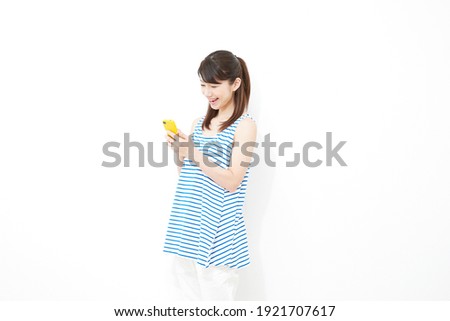 Asian woman smiling with the smartphone on white