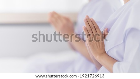 hands of religious Asian buddhist people in white cloth praying and chanting Royalty-Free Stock Photo #1921726913