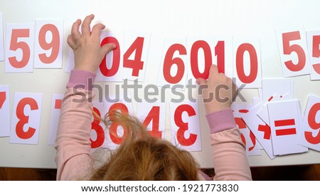 education a child count with plastic cards with numbers,childhood autism.