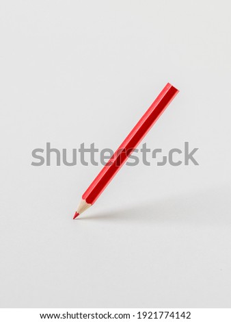 Bright red pencil on a white background. Stationery and school supplies.