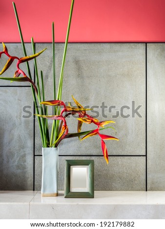 Blank modern interior wall with flowers in ceramic vase