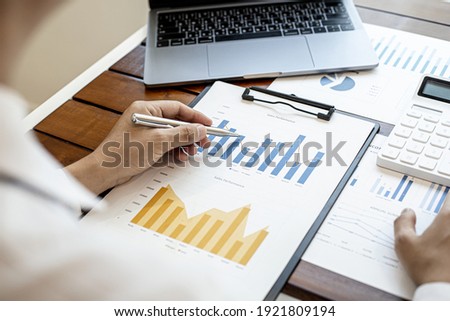 A financial businessman examines the financial information of the company, he receives documents from the finance department and sends them for verification before presenting them to the meeting. Royalty-Free Stock Photo #1921809194