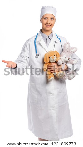 female doctor in a white coat and hat. a medic holds soft toys, a hare and a bear and smiles. the pediator held out her hand to us as a sign of an invitation to her. white background isolated