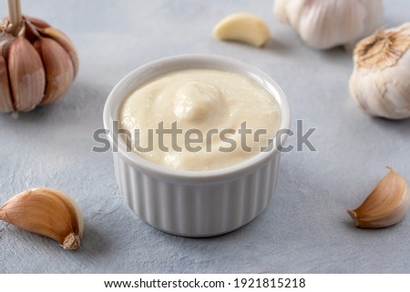 Lebanese Toum garlic sauce. All-purpose garlic sauce (no eggs) as an alternative to mayonnaise. It goes well with all dishes where garlic is appropriate. Selective focus. Royalty-Free Stock Photo #1921815218