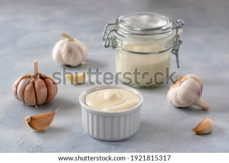 Lebanese Toum garlic sauce. All-purpose garlic sauce (no eggs) as an alternative to mayonnaise. It goes well with all dishes where garlic is appropriate. Selective focus. Royalty-Free Stock Photo #1921815317