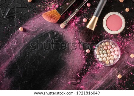 Makeup background with brushes, pearls and other products and tools, overhead flat lay shot
