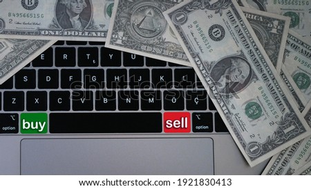 Buy and sell buttons on computer keyboard with moneys