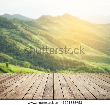 Wood desk or wood floor for product display with mountain view background 