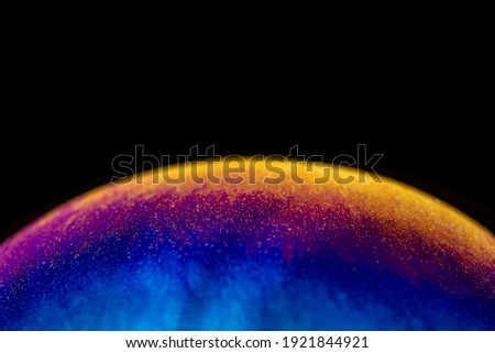 A closeup shot of a colorful sphere on black background
