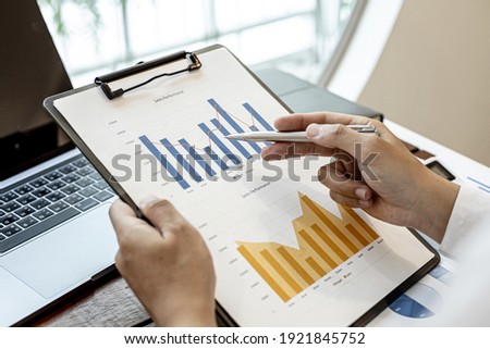 A financial businessman examines the financial information of the company, he receives documents from the finance department and sends them for verification before presenting them to the meeting.
