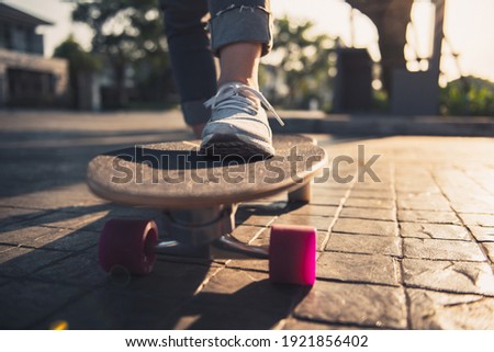 Close-up leg on surf skate on the road, Sport activity lifestyle concept, Healthy and exercise.