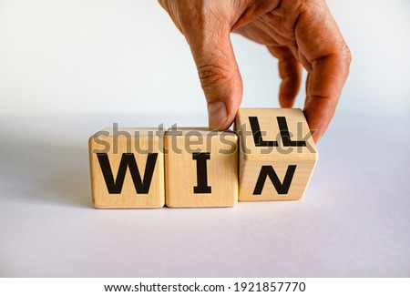 We will win symbol. Businessman turns cubes and changes the word will to win. Beautiful white background, copy space. Business, motivational and we will win concept. Royalty-Free Stock Photo #1921857770
