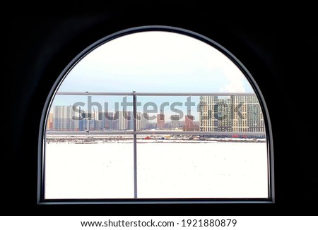 View from the attic window, on the other side of the Neva River, behind which new residential blocks are built. Saint-Petersburg, Russia.