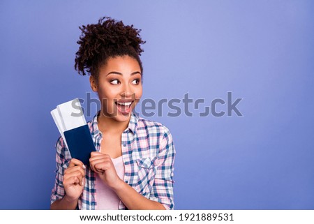 Portrait of nice optimistic brunette hairdo lady hold tickets look empty space wear white shirt isolated on vibrant blue color background