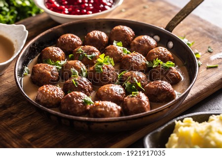 Pan with freshly-made kottbullar meatballs in a sauce. Royalty-Free Stock Photo #1921917035