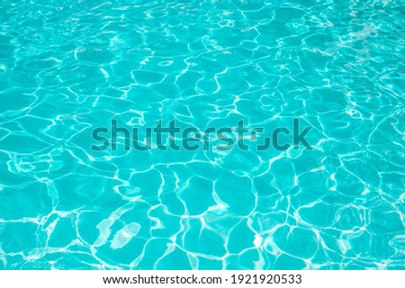 Surface of blue swimming pool. Summer background. Texture of water surface
