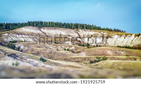 mountain landscape with flat peaks with a forest in the distance sky background, blurred image