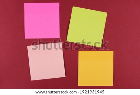 Multicolored paper stickers for writing on a red background