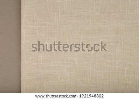 Flat linen fabric on grey textured surface - off-white linen Royalty-Free Stock Photo #1921948802