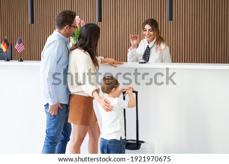 Picture of family checking in hotel