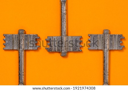 Keys on a orange background, top view. Trendy colorful photo. Minimal style with colorful paper backdrop.Trendy minimal flat lay concept.