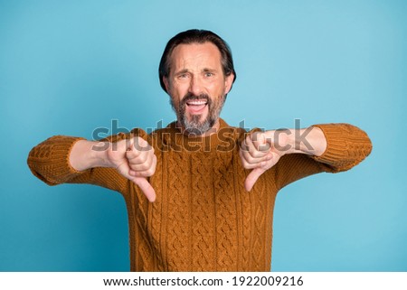 Portrait of unsatisfied person show two hands thumbs down look camera isolated on blue color background