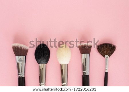 Set of large cosmetic brushes on pink background. Royalty-Free Stock Photo #1922016281