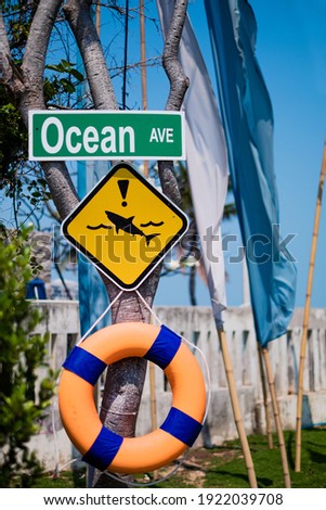 Yellow Warning Sign, Shark attack warning sign on Beach. 